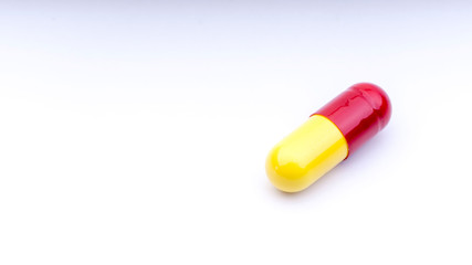 Medicine pills or capsules closeup on a white background with selective focus and crop fragment