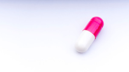 Medicine pills or capsules closeup on a white background with selective focus and crop fragment