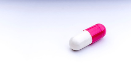 Medicine pills or capsules closeup on a white background with selective focus and crop fragment