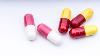 Medicine pills or capsules closeup on a white background with selective focus and crop fragment