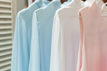 Beautiful pastel clothes on the hanger