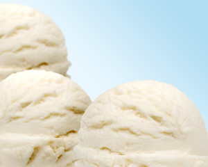 Vanilla ice cream scoops isolated on blue background