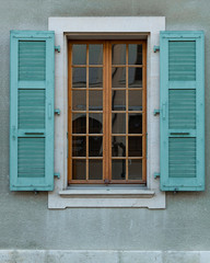 Classic window and turquoise blinds exterior view