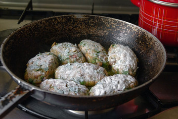 mushroom cutlets rolled in flour in a frying pan