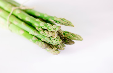 Food background asparagus flat lay pattern. bunch of fresh green asparagus on white background, top view.