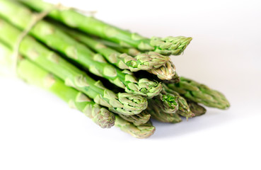 Food background asparagus flat lay pattern. bunch of fresh green asparagus on white background, top view.