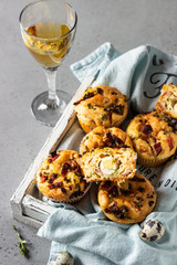 Savory muffins with bacon, quail egg, green onion cheese on a grey stone backdrop. Protein breakfast. Rustic style.