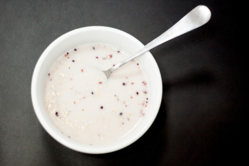snack at the workplace at the office. Diet porridge in a white plate on the table. 