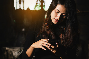 closeup of Asia workingwoman,teen girl using smartphone,mobile phone working,playing in free time with relax fun and happy on holiday.