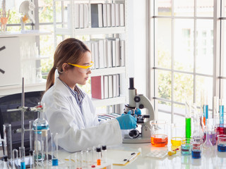 Fototapeta premium asian scientist working in laboratory with microscope