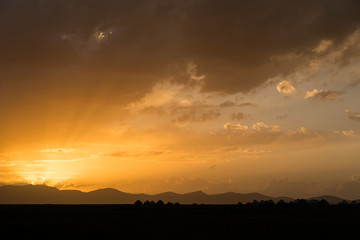 Silhouette of a yurt settlement at Song Kul lake in Kyrgyzstan at sunset