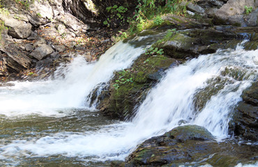 Fototapeta na wymiar small waterfalls on wild Ostravice river, Czech Republic