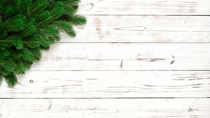 Christmas decor with fir branches on white wooden board 