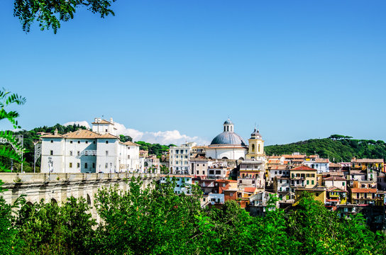 The houses of the city of Ariccia with beautiful red roofs under the blue sky. Rome. Italy.
