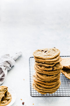 Homemade Chocolate Chip Cookies stacked on a cooling wire rack