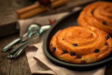 Cozy homemade cakes: sweet cinnamon and raisin buns.