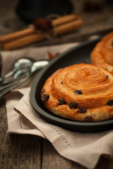 Cozy homemade cakes: sweet cinnamon and raisin buns.