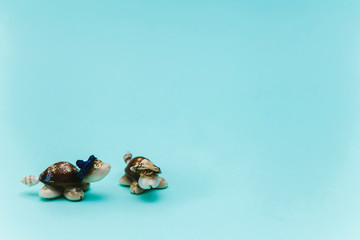 Figures of sea turtles, souvenirs brought from vacation, on a blue background