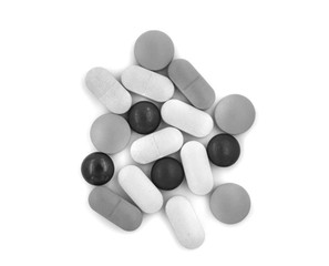 Black and white tablets (pills) on a white background