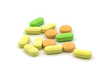 Obraz na płótnie Canvas Multicolored tablets and pills on a white background