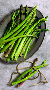 Freshly cut asparagus spears on a plate.