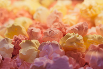 Fresh delicious colorful meringues background texture