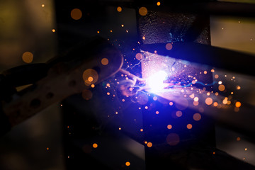 Obraz premium Welder erecting technical steel. Industrial steel welder in factory technical.