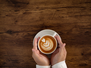 coffee latte with beautiful latte art on hand