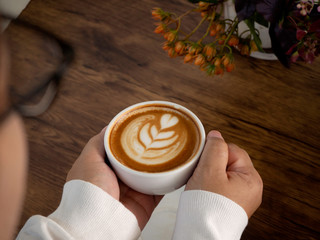 coffee latte with beautiful latte art on hand