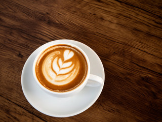 Hot coffee with soft bubble on old wooden boards.
