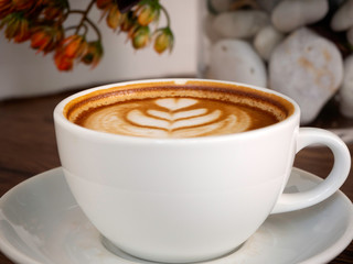Hot coffee with soft bubble on old wooden boards.