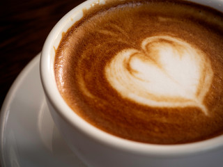 Hot coffee with soft bubble on old wooden boards.