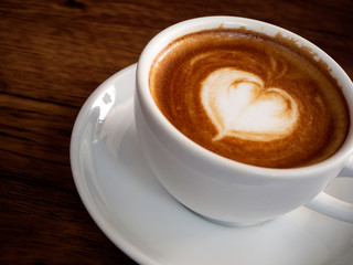 Hot coffee with soft bubble on old wooden boards.