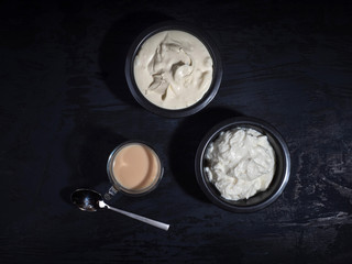 Breakfast of dairy products in dark dishes
