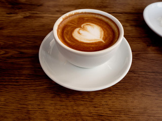 Hot coffee with soft bubble on old wooden boards.