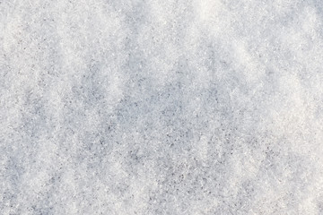 Background of crystal snow. White fresh snowy texture.