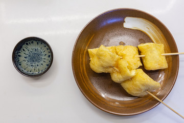 Oily tofu on a plate. Chinese snacks