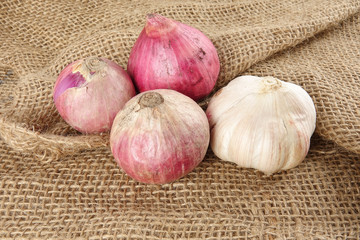 Onions on a brown rug background.