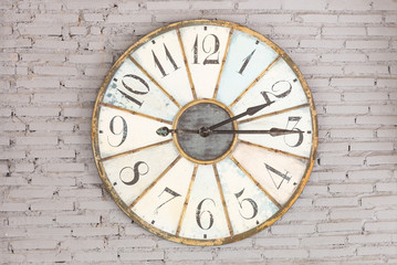 Fototapeta na wymiar Retro clock showing two fifteen on the wall