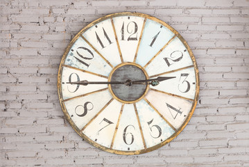 Fototapeta na wymiar Retro clock showing two forty five on the wall