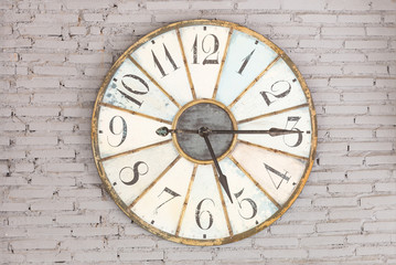 Fototapeta na wymiar Retro clock showing five fifteen on the wall