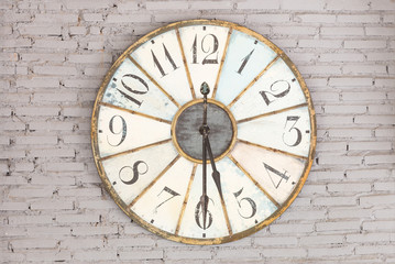 Retro clock showing five thirty on the wall