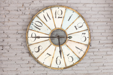 Retro clock showing five forty five on the wall