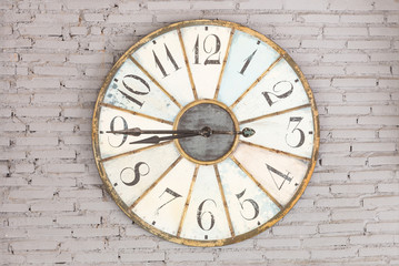 Obraz na płótnie Canvas Retro clock showing eight forty five on the wall