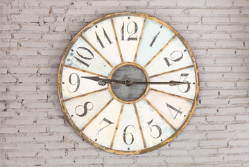 Fototapeta na wymiar Retro clock showing nine fifteen on the wall