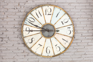 Fototapeta na wymiar Retro clock showing nine forty five on the wall