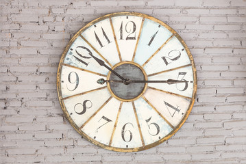 Fototapeta na wymiar Retro clock showing ten fifteen on the wall