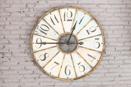 Retro clock showing twelve forty five on the wall