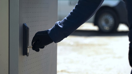 CIT guard opening ATM safe with key to load storage with cash, technical service