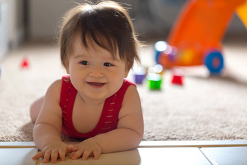 Fototapeta premium Happy little baby boy playing with his toys